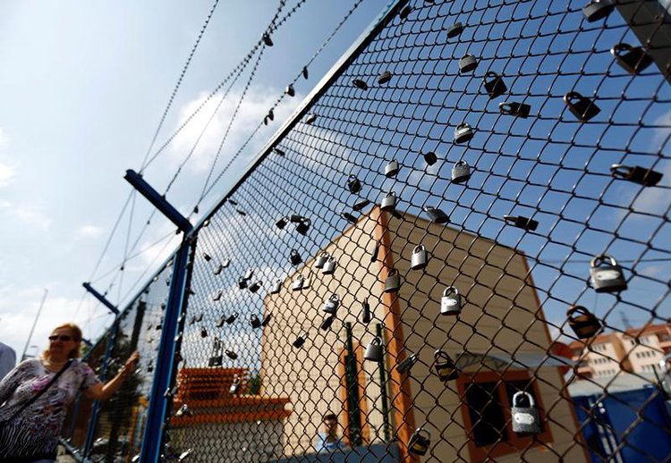 A demonstrator stands next to padlocks left by prisoners in Istanbul's Metris Prison during a protest against the arrest of journalists and press freedom advocates, June 24, 2016. (Reuters/Murad Sezer)