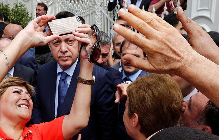 A woman takes a selfie with Turkish President Recep Tayyip Erdoğan in Istanbul, August 4, 2017. (Reuters/Murad Sezer)