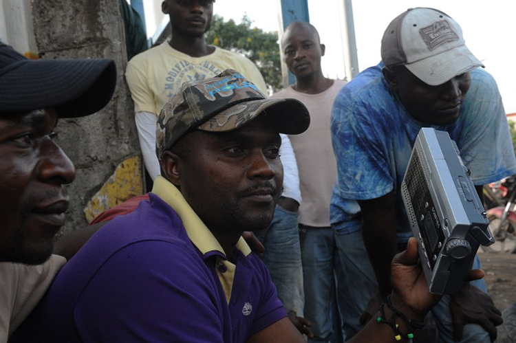 Congolese men listen to the radio in Goma, Democratic Republic of the Congo, December 11, 2011. (AFP/Simon Maina)