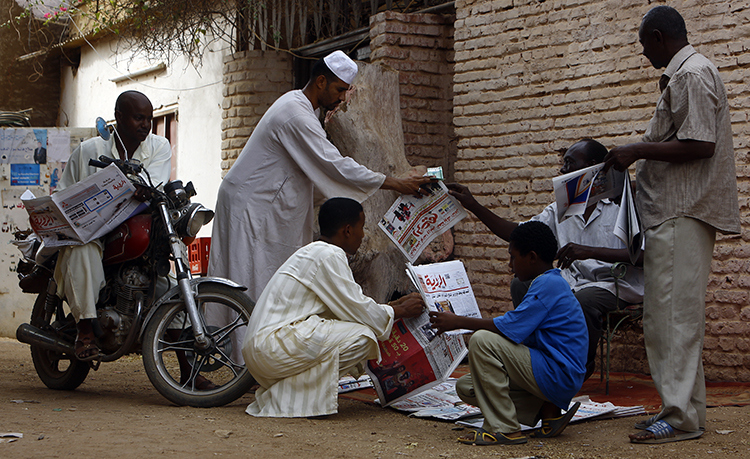 A newspaper street vendor outside the capital, Khartoum, in 2015. Sudan has fined a journalist over her critical column on the police. (AFP/Ashraf Shazly)