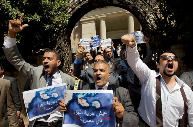 Dozens of Egyptians shout slogans during a protest in Cairo against an accord to hand over control of two Red Sea islands to Saudi Arabia. Journalist Hany Salah el-Deen is arrested on accusations of 'inciting protests.' (AP/Amr Nabil)
