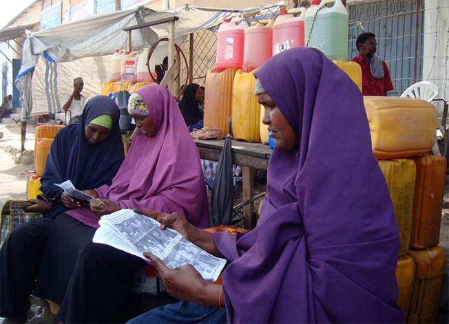 Women read newspapers in a Mogadishu market in 2010. Somali authorities are proposing changes to the country's media law, that include new restrictions for the press. (Reuters/Feisal Omar)