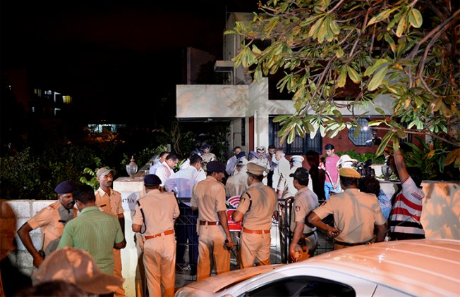 The Home Minister of Karnataka state and police gather outside the Bangalore house where journalist Gauri Lankesh was shot dead on September 5. (AFP/Manjunath Kiran)