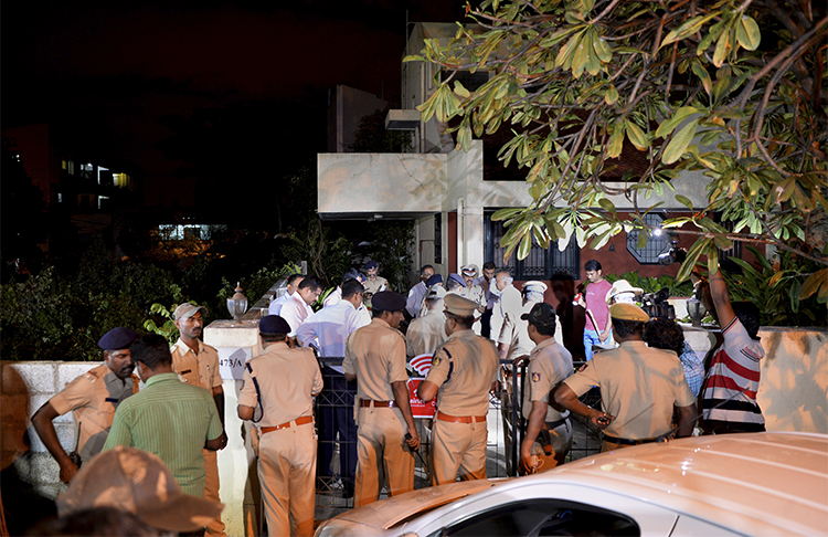 The Home Minister of Karnataka state and police gather outside the Bangalore house where journalist Gauri Lankesh was shot dead on September 5. (AFP/Manjunath Kiran)