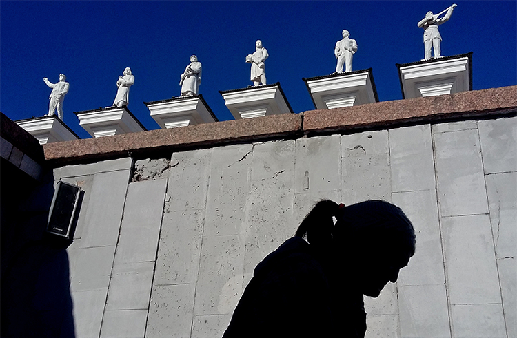 A woman walks in front of the palace of culture in Karaganda, Kazakhstan, in April 2017. A Kazakh court has banned an editor from working for three years. (AFP/Kirill Kudryavtsev)