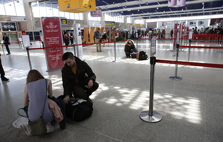 Passengers store their electronic items in their suitcases and bags when arriving at the Casablanca Mohammed V International Airport on Thursday, March 29, 2017. Moroccan authorities detained British reporter Saeed Kamali Dehghan on September 27, and then expelled him from Morocco. (AP/ Abdeljalil Bounhar)