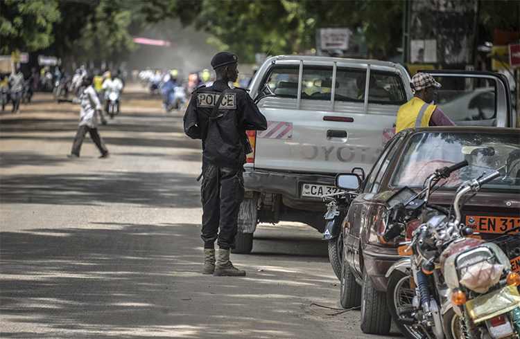 A Cameroonian police officer patrols in the northern city of Maroua in September 2016. RFI broadcaster Ahmed Abba was arrested there in July 2015. (AFP/Reinnier Kaze)