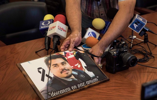 An image of slain Mexican journalist Edgar Daniel Esqueda Castro is shown during a protest before the start of a press conference at the State House in San Luis Potosi, Mexico on Friday, Oct. 6, 2017. Mexican authorities on Friday found Esqueda Castro's body in San Luis Potosi one day after armed men wearing uniforms abducted him from his home, authorities said. (AP/Christian Palma)