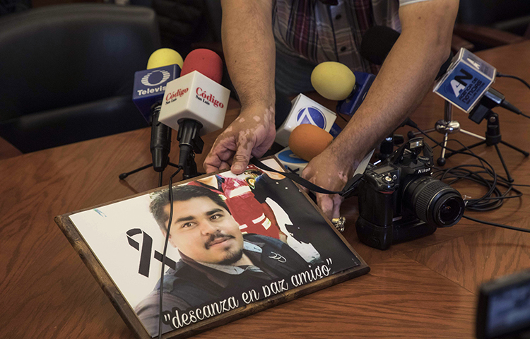 An image of slain Mexican journalist Edgar Daniel Esqueda Castro is shown during a protest before the start of a press conference at the State House in San Luis Potosi, Mexico on Friday, Oct. 6, 2017. Mexican authorities on Friday found Esqueda Castro's body in San Luis Potosi one day after armed men wearing uniforms abducted him from his home, authorities said. (AP/Christian Palma)