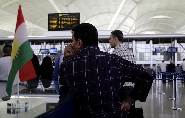 Passengers file through Erbil international airport Friday, September 29, 2017 ahead of a flight ban threatened by the central Iraqi government in retaliation for a Kurdish independence referendum. A journalist who reported critically on the referendum was ordered to leave Kirkuk province. (AP/Susannah George)
