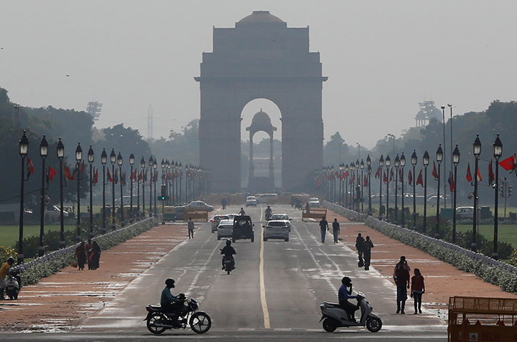 People ride past the India Gate in New Delhi, India September 1, 2017. Chhattisgarh regional police said they searched Vinod Verma's New Delhi home and allegedly found over 500 CD copies of a sex tape Verma used to extort and blackmail a government minister. (Reuters/Adnan Abidi)