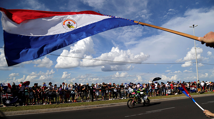 A Paraguay flag is waved during the 2017 Dakar rally in Asuncion. A draft law in Paraguay is proposing strict social media regulations. (Reuters/Jorge Adorno)