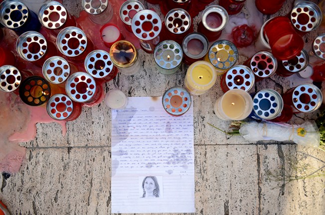 Candles and tributes are left for investigative journalist Daphne Caruana Galizia, who was murdered in Malta in October, (AP/ Rene Rossignaud)