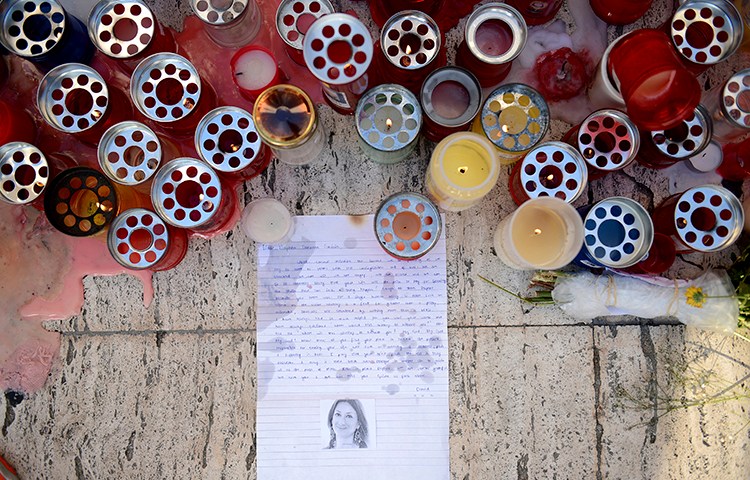 Candles and tributes are left for investigative journalist Daphne Caruana Galizia, who was murdered in Malta in October, (AP/ Rene Rossignaud)