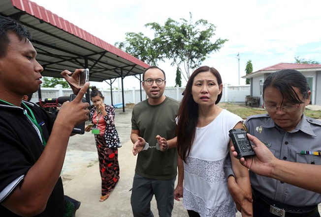 Singaporean journalist Lau Hon Meng, center left, and Malaysian journalist Mok Choy Lin, both accused for allegedly flying drones illegally over parliament buildings, are escorted during their trial at a court Friday, Nov. 10, 2017, in Naypyitaw, Myanmar. (AP/Aung Shine Oo)