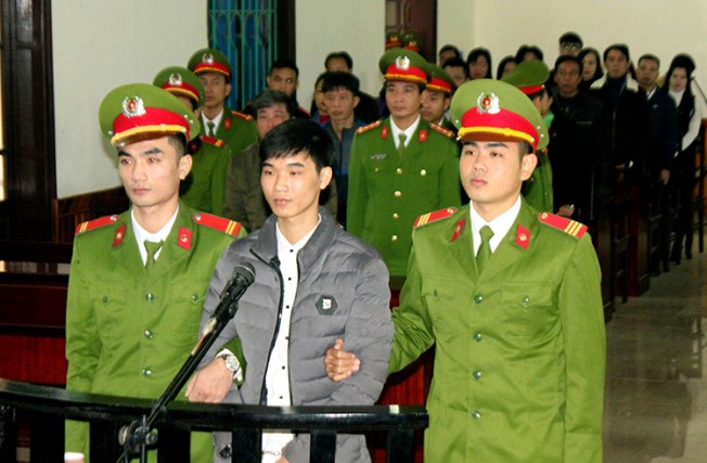 Nguyen Van Hoa, center, was sentenced to seven years in prison on November 27, 2017, after being convicted of spreading anti-state propaganda. (Cong Tuong/Vietnam News Agency/AP)