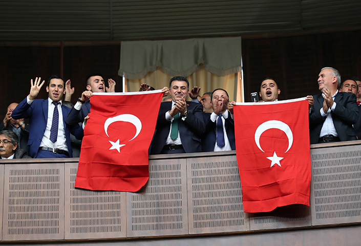 Supporters of Turkish President Recep Tayyip Erdogan cheer as he addresses parliament in Ankara, Turkey, November 7, 2017. Turkish authorities, under Erdogan's leadership, began a wide-reaching crackdown after a failed attempted coup in June 2016. (Reuters/Umit Bektas)