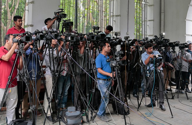 Bangladeshi journalists cover proceedings outside a Dhaka court in May 2016. The country's vaguely worded defamation law is creating a climate of self censorship, local reporters say. (AP/A.M. Ahad)