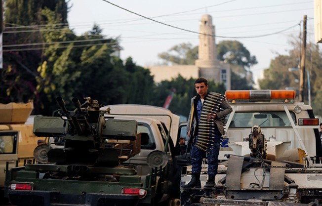 A Houthi fighter stands on a truck outside the house of Yemen's former president Ali Abdullah Saleh after Saleh was killed, in Sanaa, Yemen December 4, 2017. (Reuters/Khaled Abdullah)