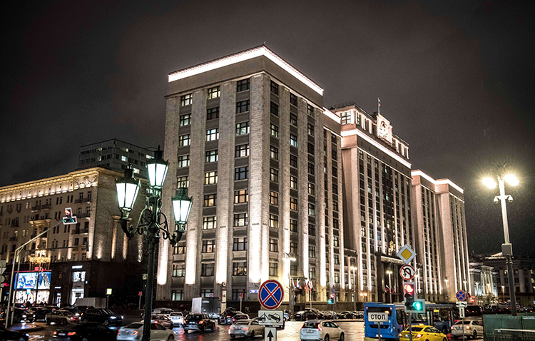 Cars drive in front of the building housing Russia's State Duma. The lower house voted in January to approve a bill that will require some journalists to register as foreign agents. (AFP/Mladen Antonov)