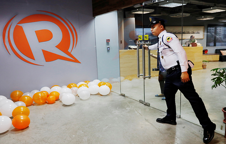 A guard opens a door at the office of Rappler in Pasig, Metro Manila, Philippines on January 15, 2018. (Reuters/Dondi Tawatao)