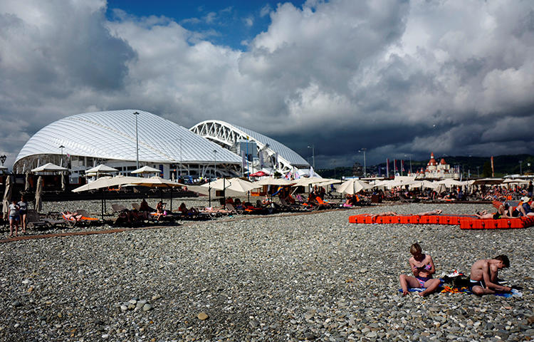 People enjoy a sunny day just outside the Fisht stadium, at the sea front in Sochi, Russia in June 2017. A Sochi court charged local blogger Aleksandr Valov with extorting money from the city's federal parliamentary deputy. (Reuters/Kai Pfaffenbach)