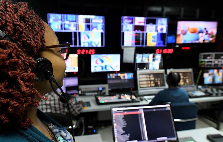 NTV employees in the station's Nairobi studio on January 19. Kenya is ignoring a court order suspending a broadcasting ban on NTV and three other stations. (AFP/Simon Maina)