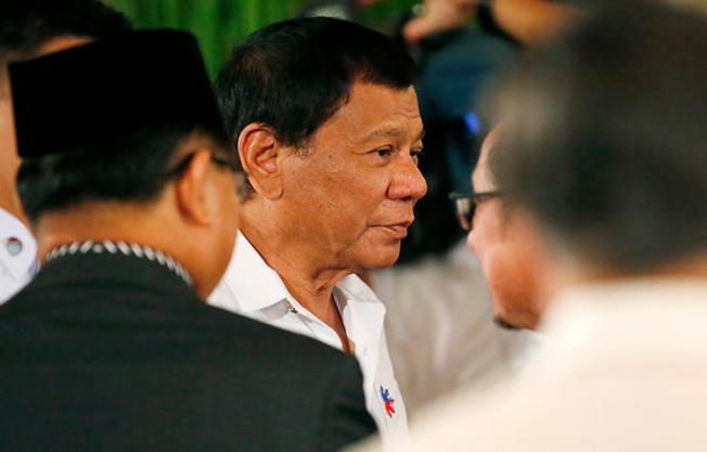 Philippine President Rodrigo Duterte, center, before he addresses Filipino Muslim leaders during a reception at the Presidential Palace to celebrate the end of the Holy Month of Ramadan in June 2017. Presidential spokesperson Harry Roque told local media the government decided to ban Rappler from covering official presidential events because Duterte had