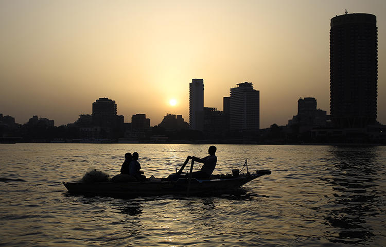 Egyptian fishermen on the Nile River as the sun sets in Cairo, Egypt, in April 2015. Ahead of presidential elections scheduled between March 26 and 28, 2018, the Egyptian government has been keen to silence any critical reporting, CPJ research shows. (AP/Hassan Ammar)