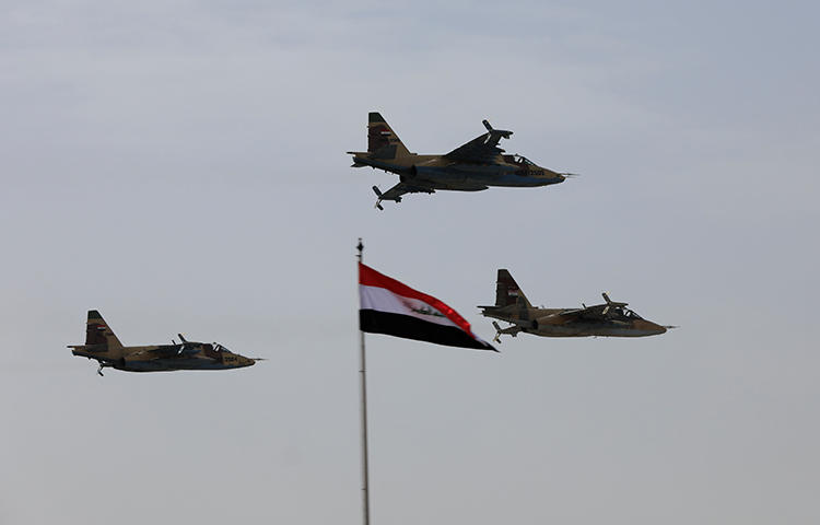 Iraqi Air Force planes fly past during Iraqi Army Day anniversary celebrations in Baghdad, Iraq on January 6, 2018. Men who identified themselves as Iraqi security forces arrested a journalist on the outskirts of Baghdad on February 2, according to reports. (Reuters/Thaier Al-Sudani)
