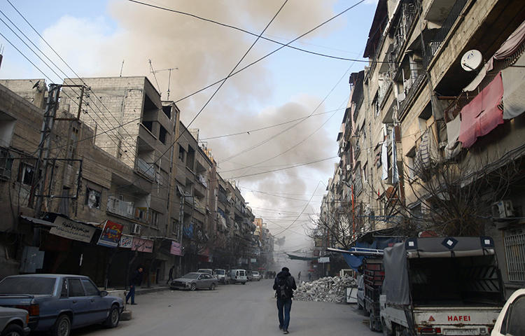 Smoke from an air raid rises in the besieged town of Douma, Eastern Ghouta, Damascus, Syria on February 23, 2018. Abdul Rahman Ismael Yassin, a reporter for the pro-opposition Hammouriyeh Media Office, died from injuries sustained in a February 20 airstrike in eastern Ghouta, according to reports. (Reuters/Bassam Khabieh)