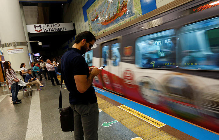 A passenger uses his smartphone as he waits for the train at a subway station in Istanbul, Turkey in June 2017. Turkey's parliament on February 21, 2018, approved an article of a bill that, if made into law, would give new censorship powers to state regulators. (Reuters/Murad Sezer)