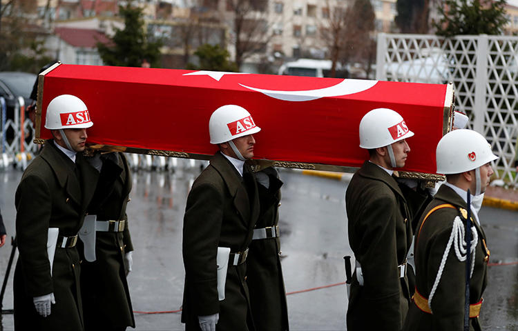 The flag-wrapped coffin of a Turkish soldier who was killed during the operation against Syria's Afrin region, is carried by guard of honor members during his funeral ceremony in Istanbul, Turkey in February 2018. Yusuf Ozan, a morning news host for the Islamist Akit TV channel, said journalists with the daily Cumhuriyet should be