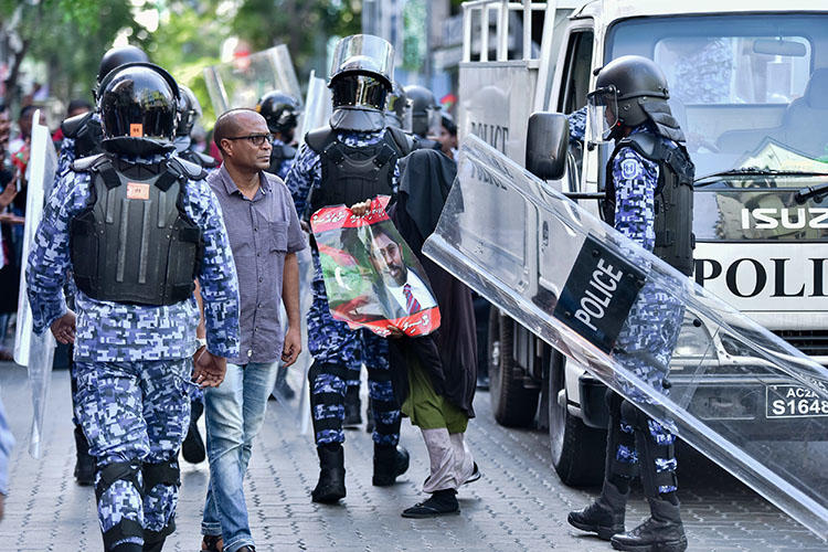 Maldivian police pictured at a protest in the capital, Malé, on March 2. Three Raajje TV journalists are detained over their coverage of anti-government protests held on March 16. (AFP/Ahmed Shurau)