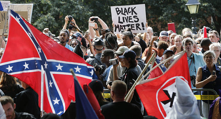 Protesters demonstrate against a KKK rally in Charlottesville, VA, in July 2017. Journalists reporting on white supremacists say they face threats and harassment. (AP/Steve Helber)