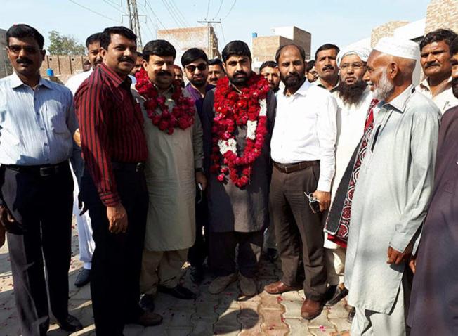 Pakistani journalist Hafiz Husnain Raza (center with garland) was released on bail March 10, 2018. (Hassaan Raza)
