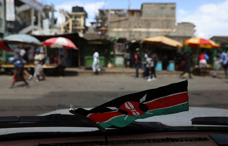 A Kenyan flag inside a car in the capital Nairobi, Kenya, October 29, 2017. According reports, police officers attacked reporters at the Jomo Kenyatta International Airport in Nairobi while they were covering an opposition politician's return to the country. (Reuters/Siegfried Modola)