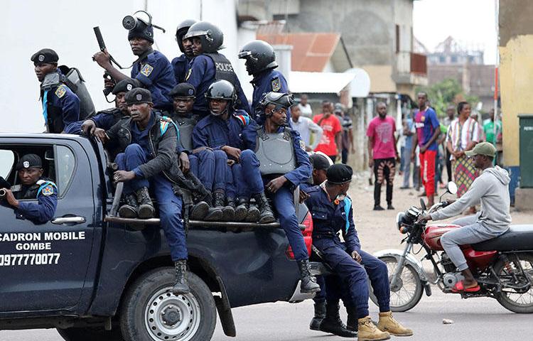 Police sit in a vehicle in front of Notre Dame Cathedral in Kinshasa, on February 25, 2018. Amid protests called by the Catholic Church, the DRC Telecommunications Ministry repeatedly orders internet and SMS shutdowns. (Reuters/Goran Tomasevic)
