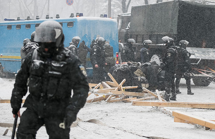 Police detain protesters while the National Guard removes a camp near the parliament building in Kiev on March 3. At least two journalists were injured while covering the unrest. (Reuters/Gleb Garanich)