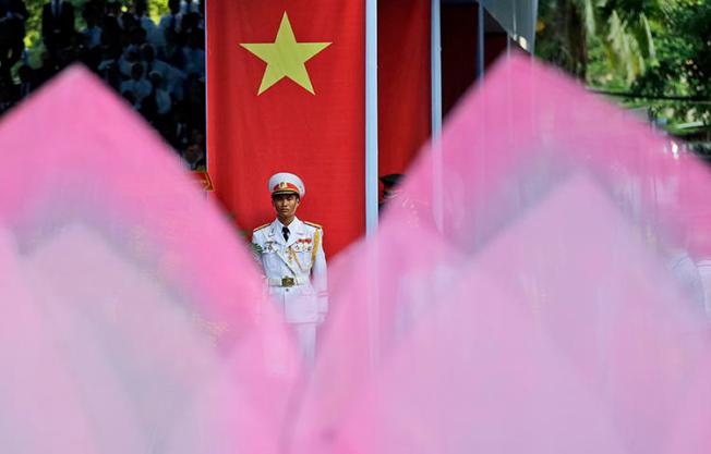 An honor guard stands at attention in Ho Chi Minh City, Vietnam, in April 2015. Plainclothes officials in Hanoi on February 24, 2018, interrogated Pham Doan Trang, an independent blogger and contributor to the Vietnam Right Now independent news website, and effectively put her under house arrest, prompting the blogger to flee, according to news reports. (AP/Dita Alangkara)