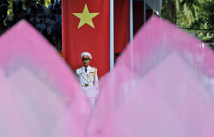 An honor guard stands at attention in Ho Chi Minh City, Vietnam, in April 2015. Plainclothes officials in Hanoi on February 24, 2018, interrogated Pham Doan Trang, an independent blogger and contributor to the Vietnam Right Now independent news website, and effectively put her under house arrest, prompting the blogger to flee, according to news reports. (AP/Dita Alangkara)