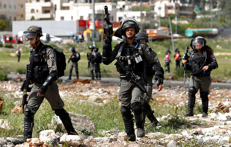 Israeli border police officers during clashes with Palestinians in the occupied West Bank on April 13, 2018. A Palestinian photographer Ahmed Abu Hussein died on April 25 from bullet wounds to his abdomen sustained on April 13 while he was covering protests in Gaza, according to reports. (Reuters/Mohamad Torokman)