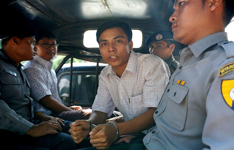 Detained Reuters journalist Kyaw Soe Oo and Wa Lone are transported in a police vehicle after a court hearing in Yangon, Myanmar on April 20, 2018 . (Reuters/Ann Wang)