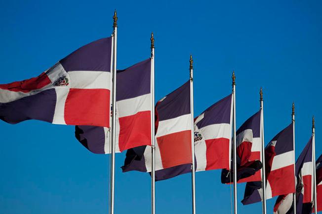 Dominican flags in Santo Domingo in 2012. A Noticias SIN reporter says threats were made against her after she reported on the murder of a fellow journalist. (AFP/Erika Santelices)