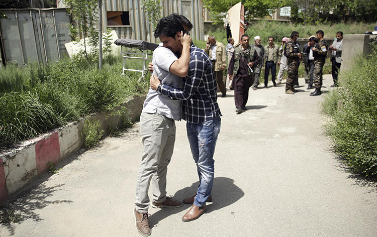 Journalists mourn for their colleagues who were killed in a suicide bombing in Kabul on April 30, 2018 that killed at least nine members of the press. (AP/Massoud Hossaini)