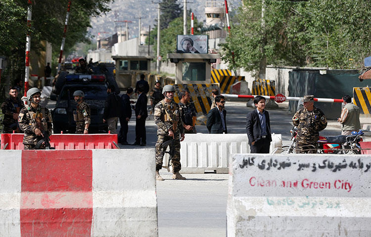 Afghan security forces stand guard near the site of a blast in Kabul, Afghanistan on April 30, 2018. At least 25 people were killed, including eight journalists, in double suicide bombing attack in Kabul on April 30, 2018, according to reports. (Reuters/Omar Sobhan)