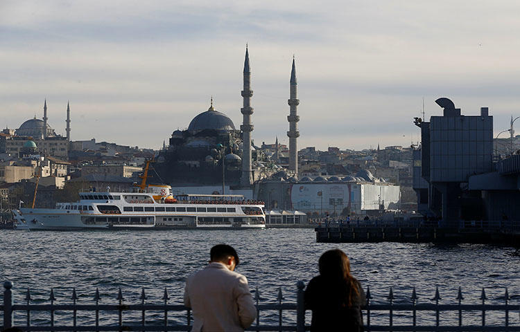People relax near Golden Horn in Istanbul, Turkey on April 4, 2018. An Istanbul court convicted in a retrial Hasan Cemal, a veteran journalist and a columnist for the news website T24, on charges of "making propaganda for a [terrorist] organization," according to news reports. (Reuters/Osman Orsal)