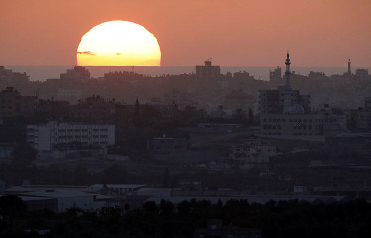 The sun sets over the Gaza Strip on May 14, 2018. Seven Palestinian journalists were injured by gunfire in Gaza protests on May 14, according to reports. (Reuters/Amir Cohen)
