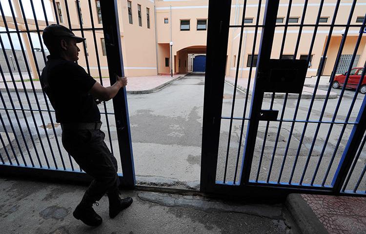 A guard opens the gates of a prison near Béjaïa in 2011. A court in the Algerian city sentenced a blogger to 10 years in prison. (AFP/Farouk Batiche)