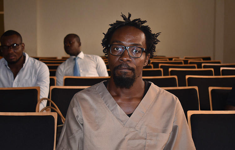 Cartoonist Ramón Nsé Esono Ebalé, pictured in court in February 2018. The journalist was acquitted and released from jail but authorities in Equatorial Guinea have not renewed his passport, which means Esono Ebalé cannot return to El Salvador. (AFP/Samuel Obiang)